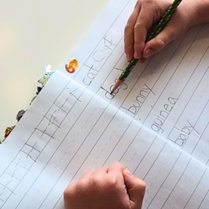 child practicing printing skills